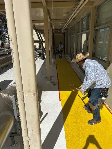 man installing walkway system on new roof