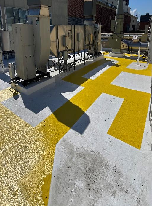white silicone roof system with yellow walkways