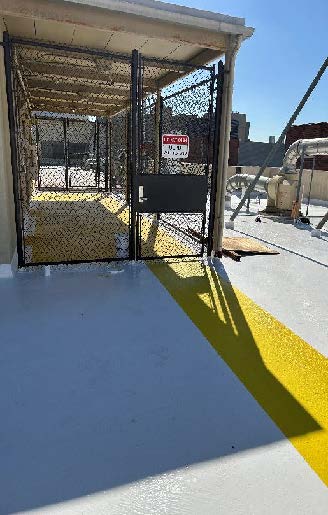 white silicone roof system with yellow walkways