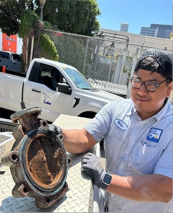 facilities technician holding chiller plant piece