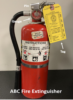 fire extinguisher with pin, gauge, and tag labeled