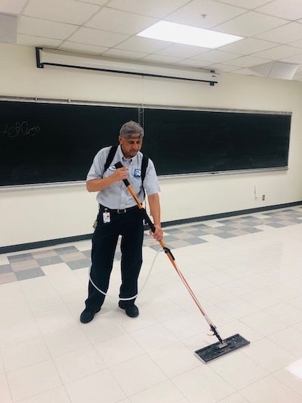 floor care team member cleaning floor