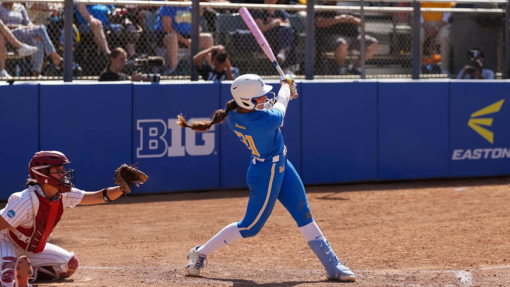 a women's softball player swings her bat at easton stadium