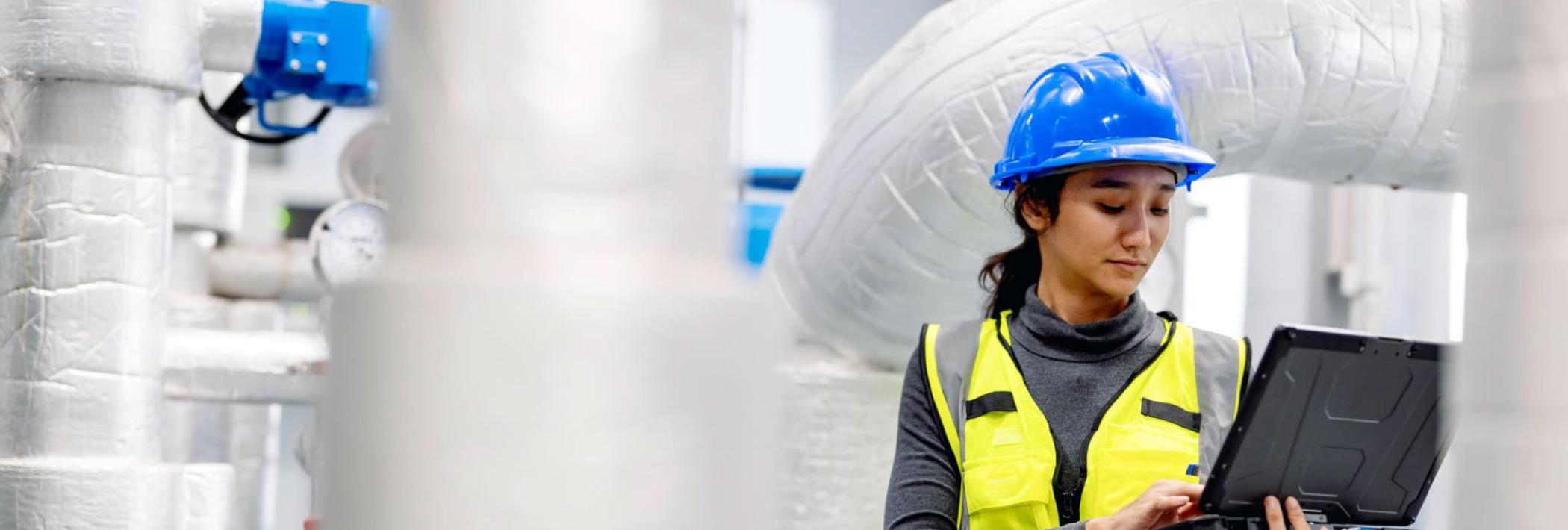 a hvac technician analyzing the output of an HVAC system on her laptop