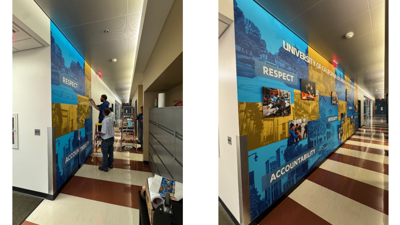 facilities team members installing mural