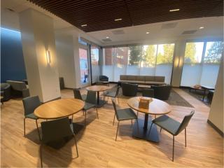 updated seating area with tables and chairs in public health building