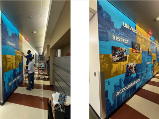 facilities team members installing mural