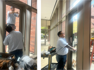 one man standing on the ground, and another man on an orange ladder working together to install new doors